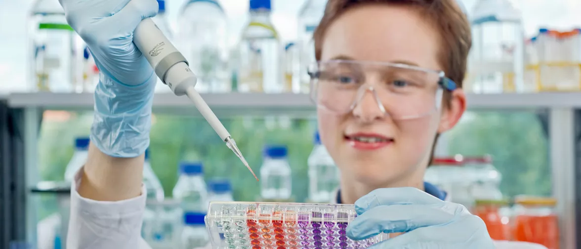 Life Sciences Nutrition student pipetting.
